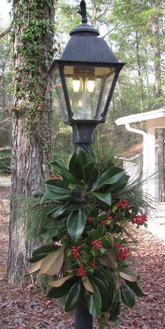 a lamp post with a christmas wreath on it