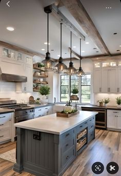 a large kitchen with an island in the middle and lots of lights hanging from the ceiling