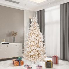 a white christmas tree with presents on the floor