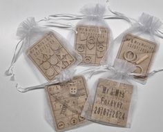 four wooden tags in organ bags with string