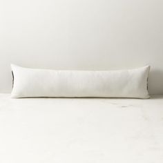 a white pillow sitting on top of a table