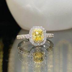 Sterling Silver Yellow Sapphire & White Topaz Halo Ring ...Marked 925...Total of weights 2.0gramsMeasure of Stone center 4 x 3.5MM... Measure of Face 9MM....It's in very good condition.