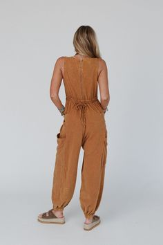 Get ready to look effortlessly boho - chic and ready - to - go in the Turning Point Washed Cargo Jumpsuit, it's sure to snag compliments! You'll want to wear this jumpsuit on the daily because it features: Comfortable, stretch, mineral - washed fabric Fitted/relaxed bodice silhouette (adjustable/elastic along the back) and a loose/baggy fit along the bottom Classic high - rise round neckline with a sleeveless design Zip - up back closure along with an elastic back waistline and self - tie strap Relaxed Fit Brown Jumpsuits And Rompers For Fall, Bohemian Relaxed Fit Overall Jumpsuit, Bohemian Jumpsuits And Rompers With Pockets For Beach, Bohemian Sleeveless Overalls With Pockets, Casual Brown Overall Jumpsuits And Rompers, Casual Brown Jumpsuits And Rompers Overall, Brown Loungewear Jumpsuits With Pockets, Casual Sleeveless Jumpsuits And Rompers For Festival, Brown Relaxed Fit Overall Jumpsuit