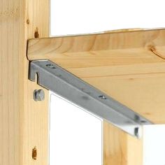 a close up of a wooden frame with metal brackets