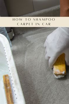 a person in white gloves cleaning carpet with a sponge