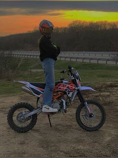 a person on a dirt bike at sunset