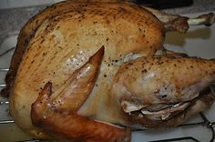 a whole chicken sitting on top of a metal rack