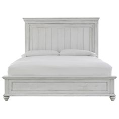 a white bed with wooden headboard and foot board