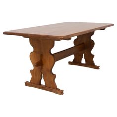 a wooden table with an intricate design on the top and bottom, against a white background