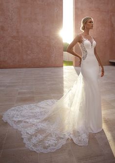 a woman in a wedding dress standing on the floor