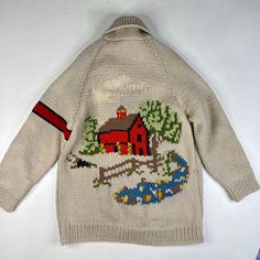 a sweater with a farm scene on it