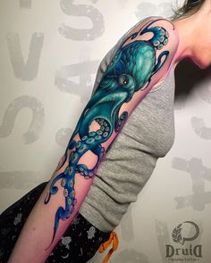 an octopus tattoo on the arm and shoulder