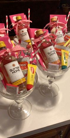 bottles of liquor and candy in wine glasses on a table