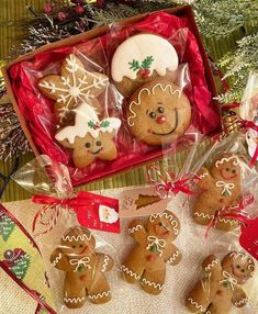 gingerbread cookies decorated with icing and decorations in a red box on a table