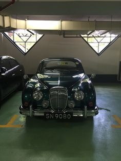 two cars parked in a parking garage next to each other