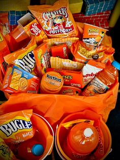 an orange bucket filled with lots of snacks