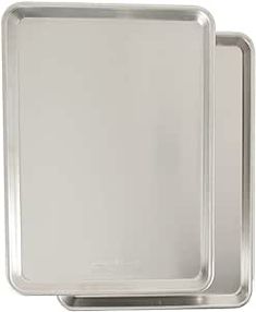 two square pans with handles on each side and one holding an empty baking sheet