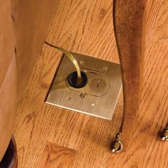 a wooden floor with a light switch on it and some screws in the middle