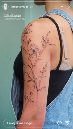 the back of a woman's arm with flowers on it and an inscription that reads,