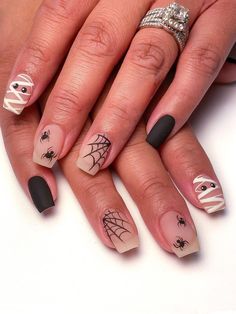 a woman's hands with black and white nail designs