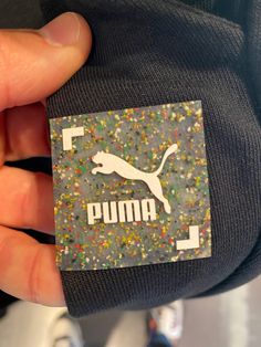 a person holding onto a puma bag with sprinkles on it