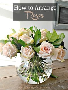 a vase filled with pink roses on top of a wooden table