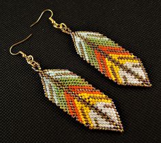 Welcome to Kartika Earrings Australia. You are buying, 1 Pair of Handmade Beaded Dangle Fashion Earrings. BEADED SHAPE - Leaf BEADED PATTERN SIZE - 75mm Long X 25mm Wide OVERALL EARRING LENGTH - 90mm Long BEAD COLOURS - Gold White Green Orange Yellow GOLD COLOUR HOOKS - LEAD FREE, NICKEL FREE, CADMIUM FREE ALL OUR EARRINGS ARE HANDMADE IN AUSTRALIA We post every morning and afternoon. Please allow 3 - 10 days postage time within Australia. Please allow 10 - 28 days postage Worldwide. Thank you R Orange Beaded Earrings, Earrings Beaded, 28 Days, Gold Colour, Leaf Shapes, Green Orange, Earrings Gold, Orange Yellow, White Green