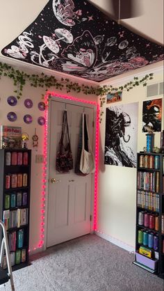 a room with bookshelves, posters and bags on the wall next to it