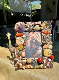 a photo frame with an image of a lion in the center and shells around it