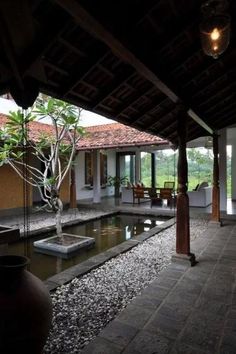 the inside of a house with a small pond