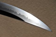 a close up of a knife on top of a cardboard box