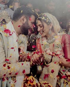 the newly married couple are surrounded by petals