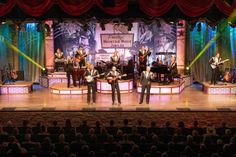 a group of people that are standing on a stage