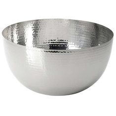 a large silver bowl sitting on top of a white table