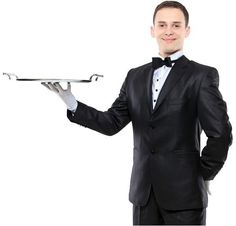 a man in a tuxedo is holding a tray with silverware on it