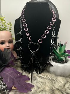 Handmade Chain Mail Necklace featuring a heart centerpiece with sword and spikes! Spike chains have claws on one side so you can change how they sit! ꘎ 𝔸𝕓𝕠𝕦𝕥 ❥ Makes the perfect gift! ❥ Made of Aluminum Rings ❥ Adjustable Length at back, let me know if you want an extension! ꘎꘎ 𝕊𝕙𝕚𝕡𝕡𝕚𝕟𝕘 ❥Can take up to 7 days or more to ship out! Punk Necklace With Lobster Clasp For Halloween, Edgy Choker Necklace For Valentine's Day, Valentine's Day Punk Party Jewelry, Punk Necklaces For Halloween Concert, Emo Metal Necklace For Party, Punk Style Necklaces For Halloween Concert, Emo Style Metal Necklace For Party, Gothic Chain Jewelry For Valentine's Day, Gothic Valentine's Day Chain Jewelry