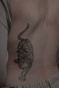 a man with a tiger tattoo on his stomach