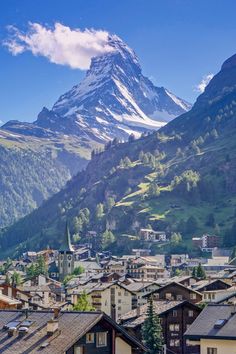 a mountain is in the distance with houses below