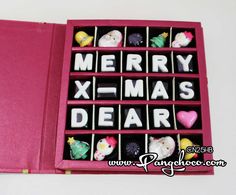 a pink box filled with lots of small christmas decorations