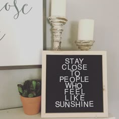 a sign that says stay close to people who feel like sunshine is next to a potted plant