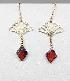 "Lovely gold Vermeil earrings with red Cubic Zirconia (CZ). These earrings evoke the romantic style of a bygone era known as the 1920's where Art Deco design was all the rage! The Vermeil fan shape is both feminine and stylish with a clear red CZ gemstone that is faceted and cut into a diamond shape that enhances its pure red color! Simply stunning, you will not go unnoticed while wearing these beauties. Perfect for your next holiday event or any other occasion. These earrings are light weight a Elegant Christmas Drop Earrings, Elegant Round Christmas Earrings, Elegant Christmas Celebration Earrings, Ornate Red Earrings For Party, Yellow Gold Pierced Crystal Earrings For Gift, Yellow Gold Pierced Crystal Earrings As Gift, Pierced Yellow Gold Crystal Earrings As Gift, Elegant Christmas Jewelry With Dangle Shape, Elegant Christmas Jewelry With Matching Earrings