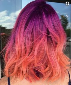 the back of a woman's head with pink and orange hair