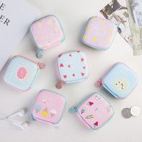 five small pink and blue purses sitting on top of a white table next to coins