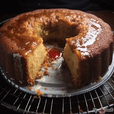 a cake that has been cut in half and is on a cooling rack with one slice taken out