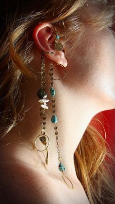 The mystery of the land & the sea combined in this boho chic ear wrap. Brass coin chain tassels adorned with natural abalone, baroque stick pearls & genuine Kingman turquoise, this ear wrap will definitely enchant your eyes. Topped off with a north star coin charm & amazonite accent, you will never get bored with this one of a kind accessory. Ear wraps require no additional piercings so pair this cute piece with your other favorite earrings to create a truly unique ear party! ✿ Hand shaped & ham Ear Wraps, Boho Chic Design, Ear Party, Sea Snail, Brass Charms, Hand Shapes, Kingman Turquoise, Brass Frame, North Star