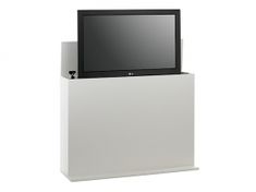 a flat screen tv sitting on top of a white cabinet