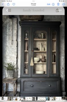 an old fashioned china cabinet with glass doors and shelves in the middle is shown on instagram