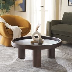 a living room scene with focus on the coffee table and chair in the foreground