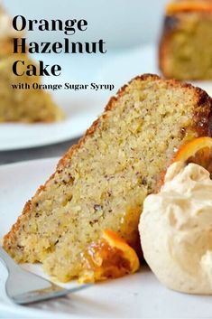 a slice of orange cake on a white plate with ice cream and an orange in the background