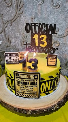 a yellow and black cake sitting on top of a wooden table next to a wall